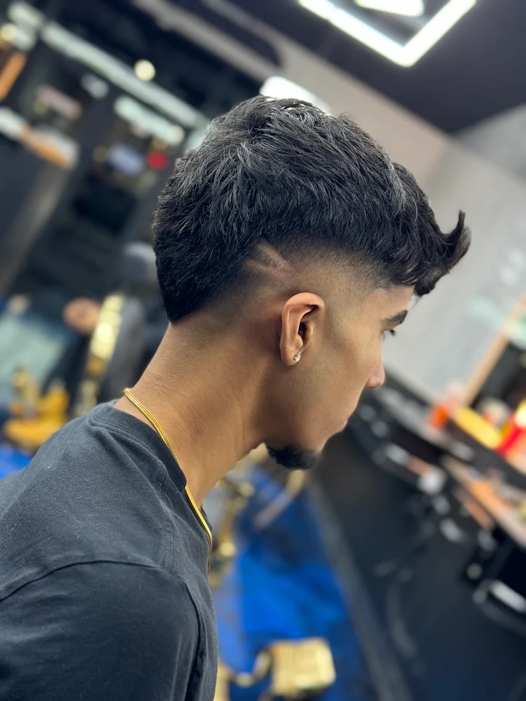 Professional haircut with textured hair on top and clean fade on sides